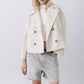 Black short double breasted wool coat worn open over a knit and grey shorts