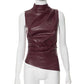 Sleeveless faux leather top styled with cargo trousers for an evening look