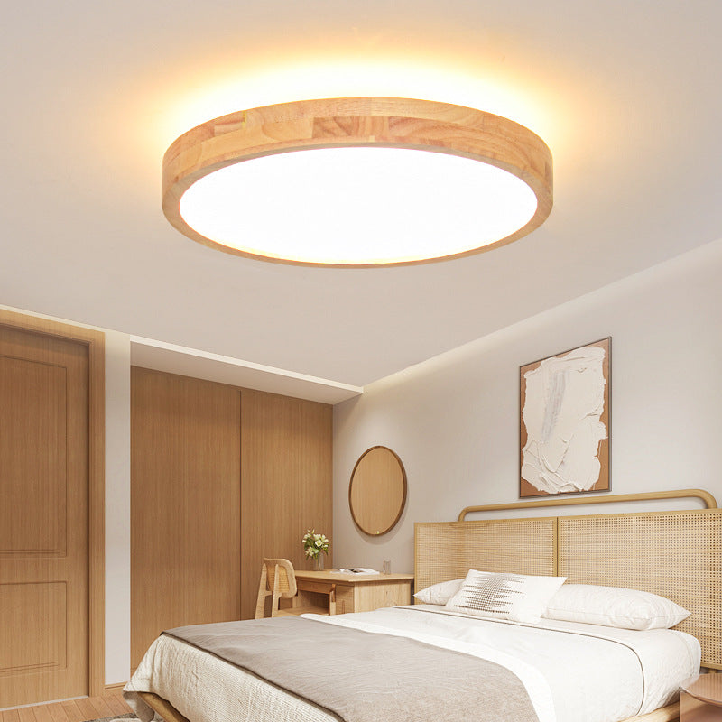 Round 40 cm solid wood LED ceiling lamp with backlight halo above a bed in a bedroom, stepless dimming