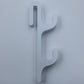 White resin single sided double hook with two arms stacked, seen from the front on a light background