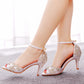 Rhinestone peep toe stiletto sandal with a cut away side and a covered heel counter