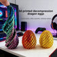Red gold 3D printed dragon egg fidget toy with overlapping scale texture on white