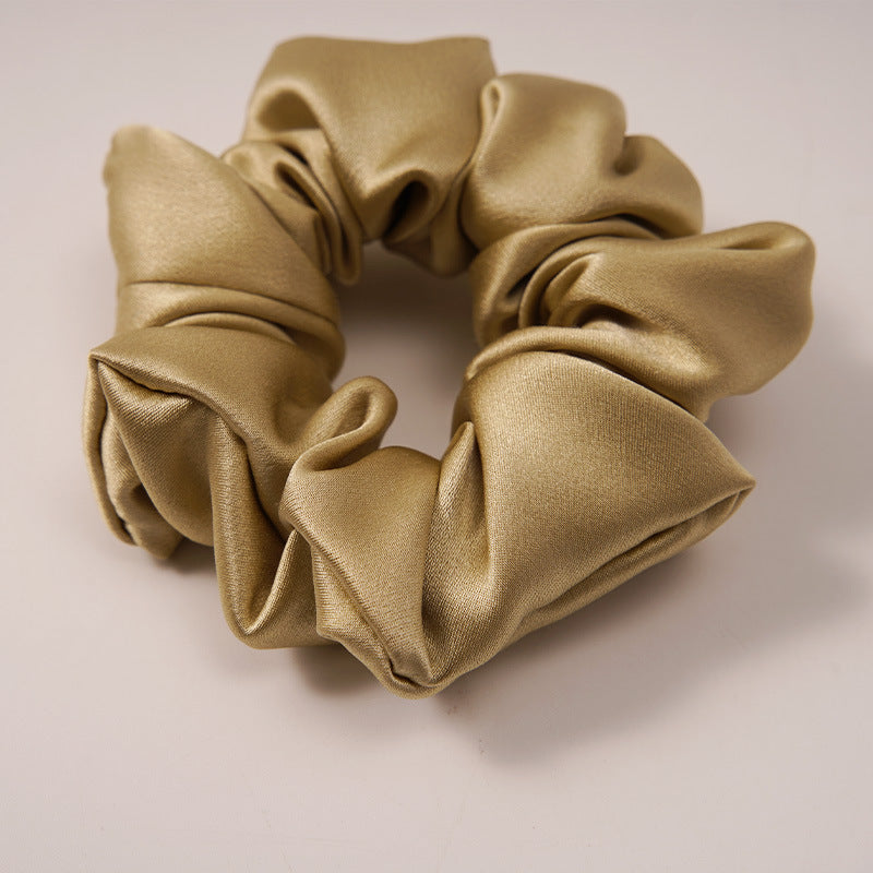 Elegant gray satin scrunchie shown close up