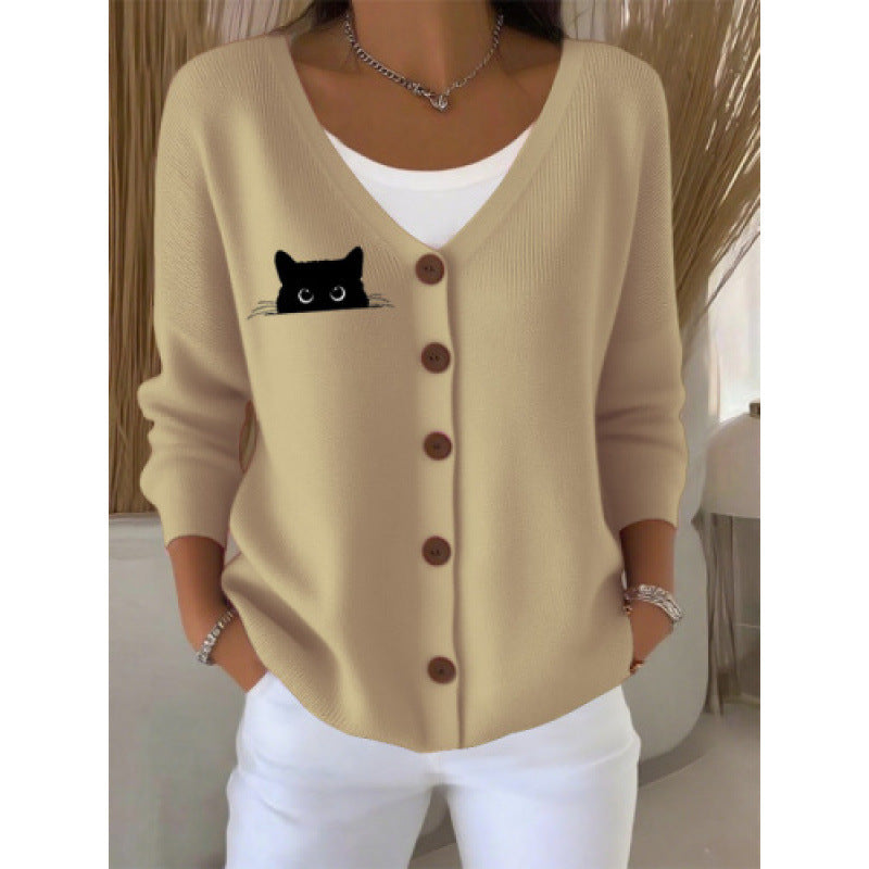 Women's V neck button front knit cardigan in the Beige Peeking Cat print worn open over a white top
