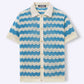 Flat lay of blue and cream chevron ripple knit polo shirt button front