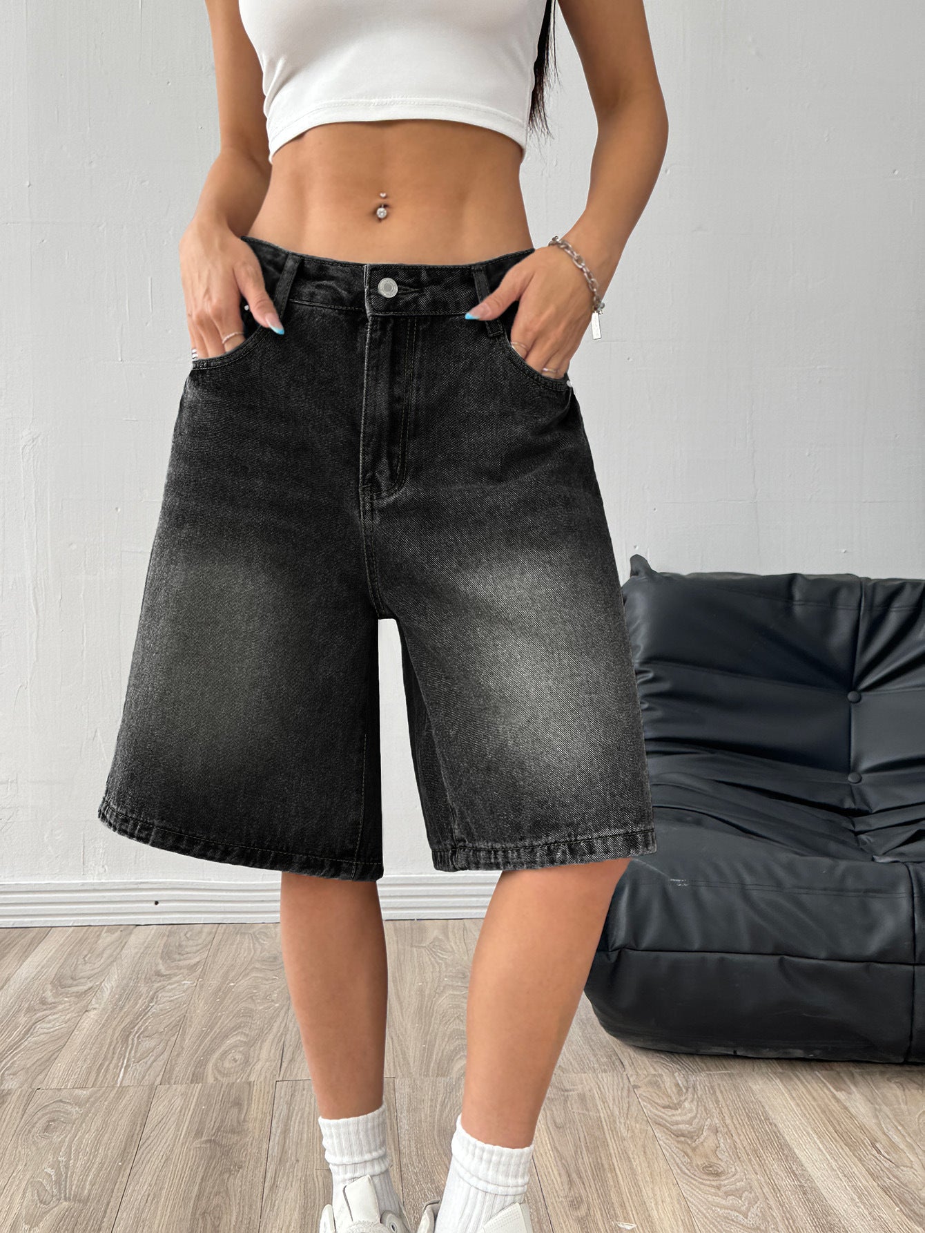 Women's denim wide-leg shorts in deep black on a clean studio background