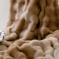 Plush throw blanket shown with matching pillow covers styled on a sofa