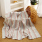 Pure cotton muslin swaddle blanket rolled up, showing the airy gauze texture and printed design