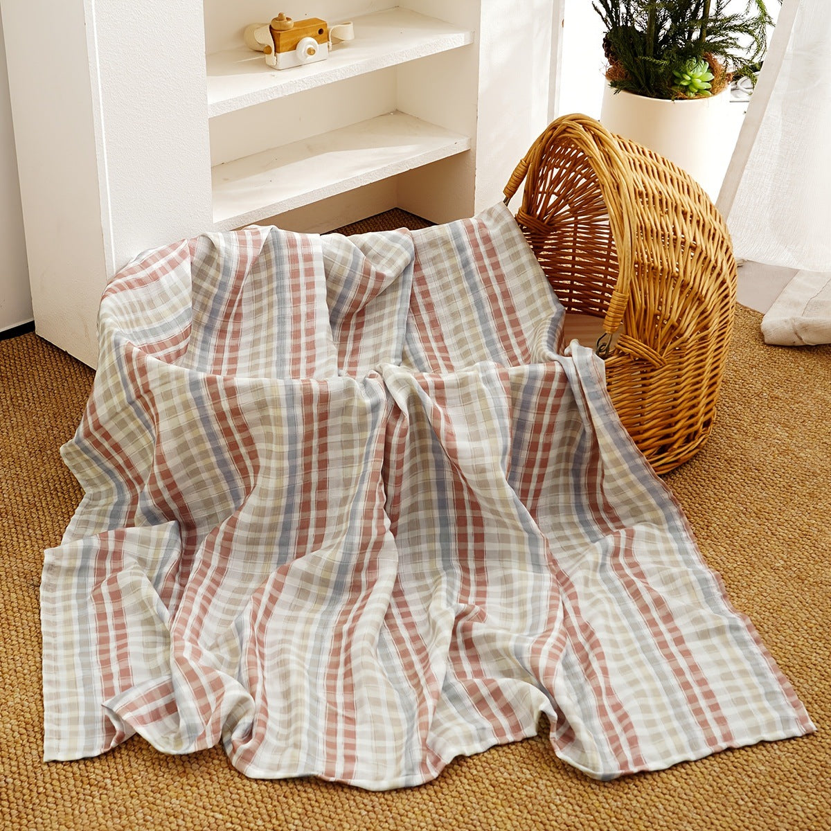 Pure cotton muslin swaddle blanket rolled up, showing the airy gauze texture and printed design