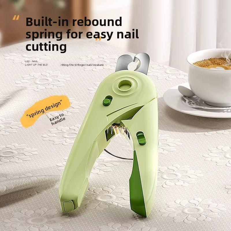 Green LED pet nail clipper showing the rebound spring between the contoured handles and the LED button