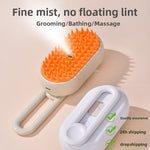 Cream pet spray brush with orange rubber bristles and a fine mist leaving the center nozzle, beside a white brush back