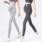 Two women in light gray and dark gray ankle length maternity leggings with belly panels, white trainers
