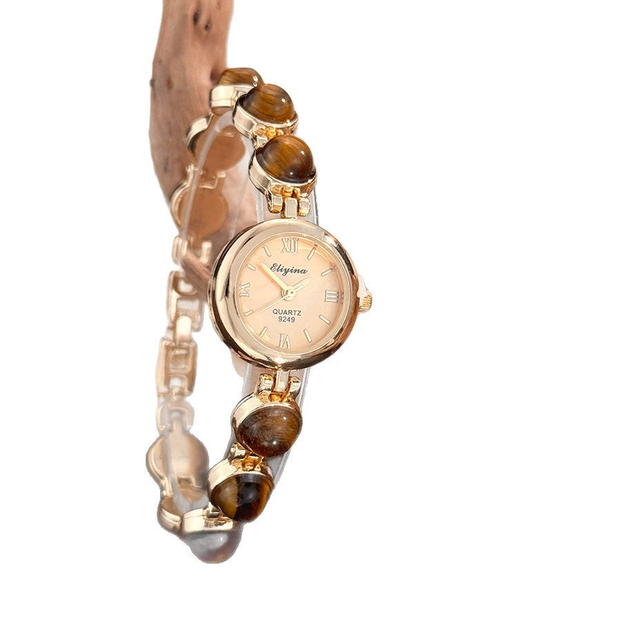 Stone beaded bracelet watch with a pale green stone band and gold tone bezels