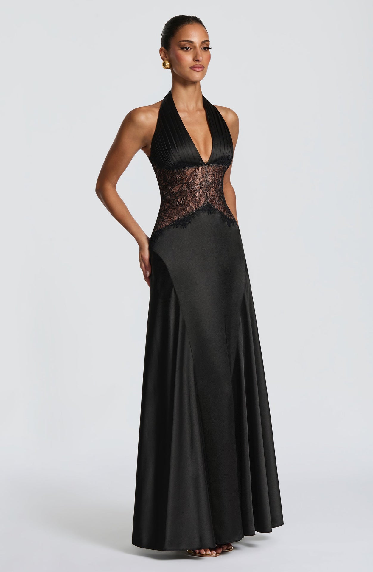 Black halter maxi gown from the side, pleated bodice and sheer lace waist