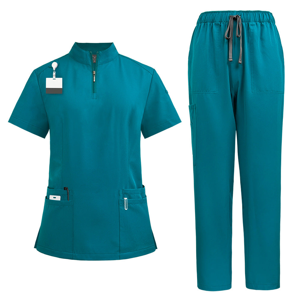 Womens scrub top in turquoise worn from the front to show the fitted cut and collar zip