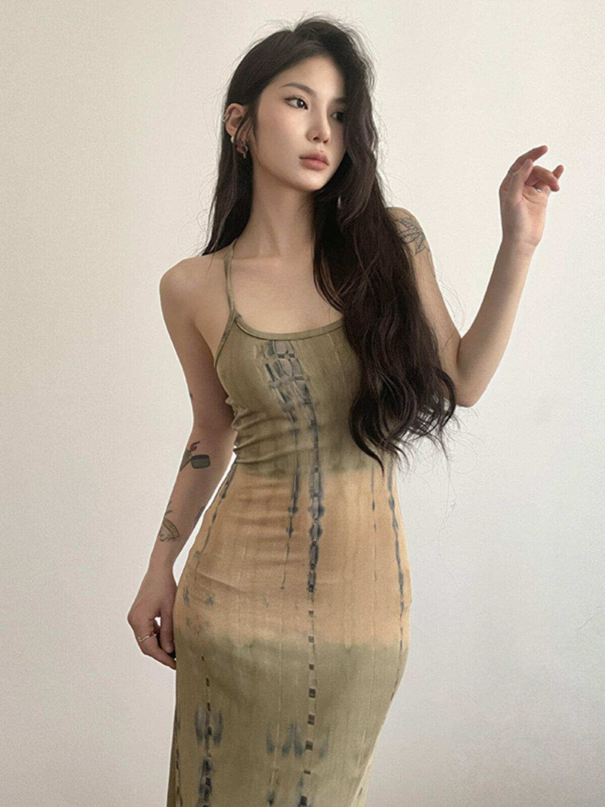 Close-up of the subtle all-over print on the khaki dress fabric