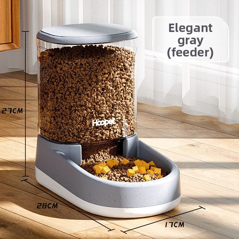 Gravity pet food feeder with a clear tank full of dry kibble over a bowl