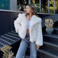 Vegan faux fur winter jacket with long full sleeves and a hip length cropped cut