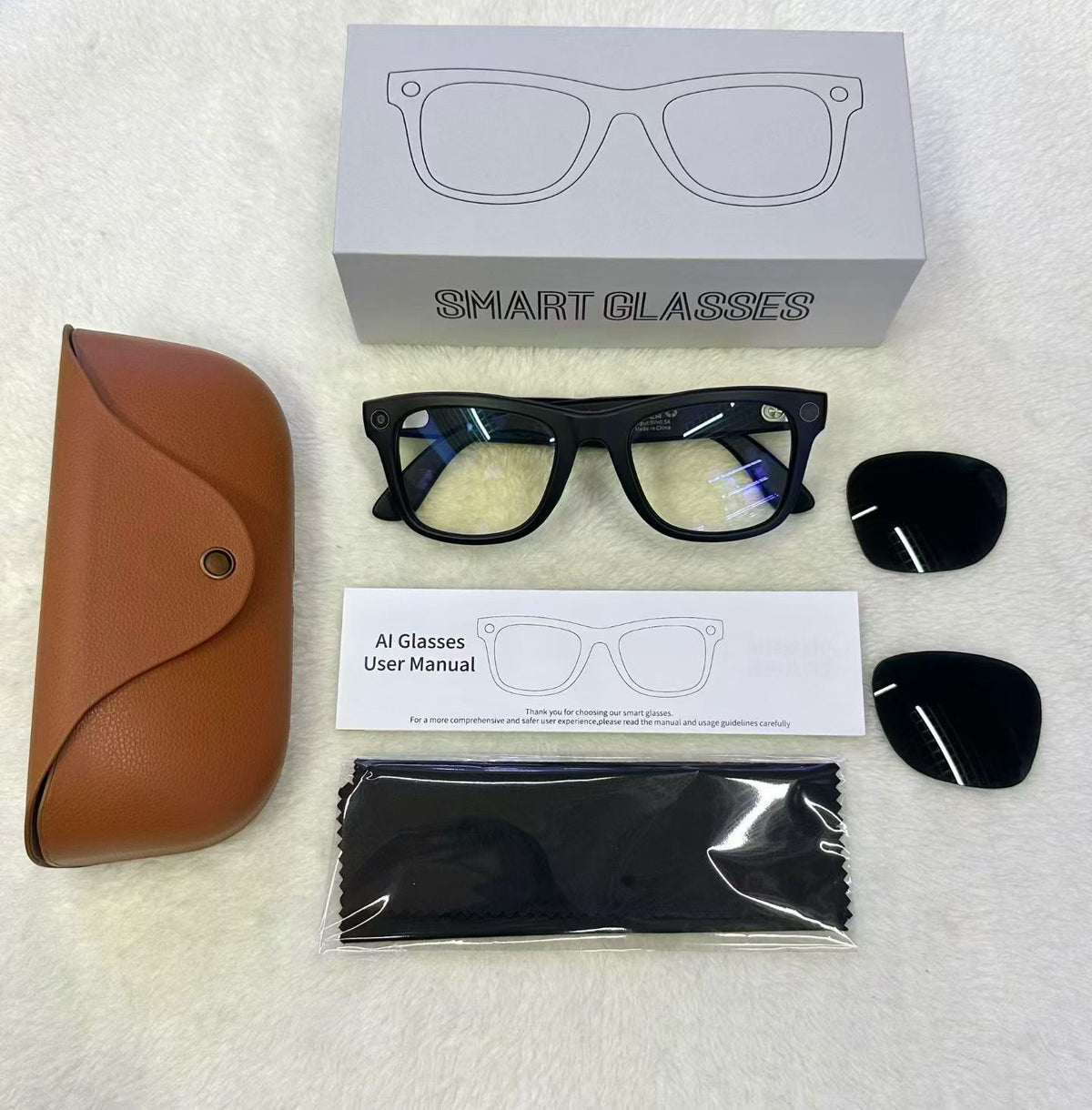 MT5 smart glasses unboxing with brown case, spare tinted lenses, cloth and manual beside a Smart Glasses box