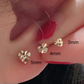 Macro detail of the gold heart stud surface and set zircon accent stone