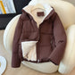 Close view of a zippered front pocket on the quilted hooded puffer jacket