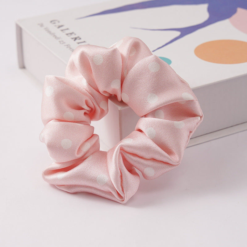 Satin hair scrunchie shown next to a gift box