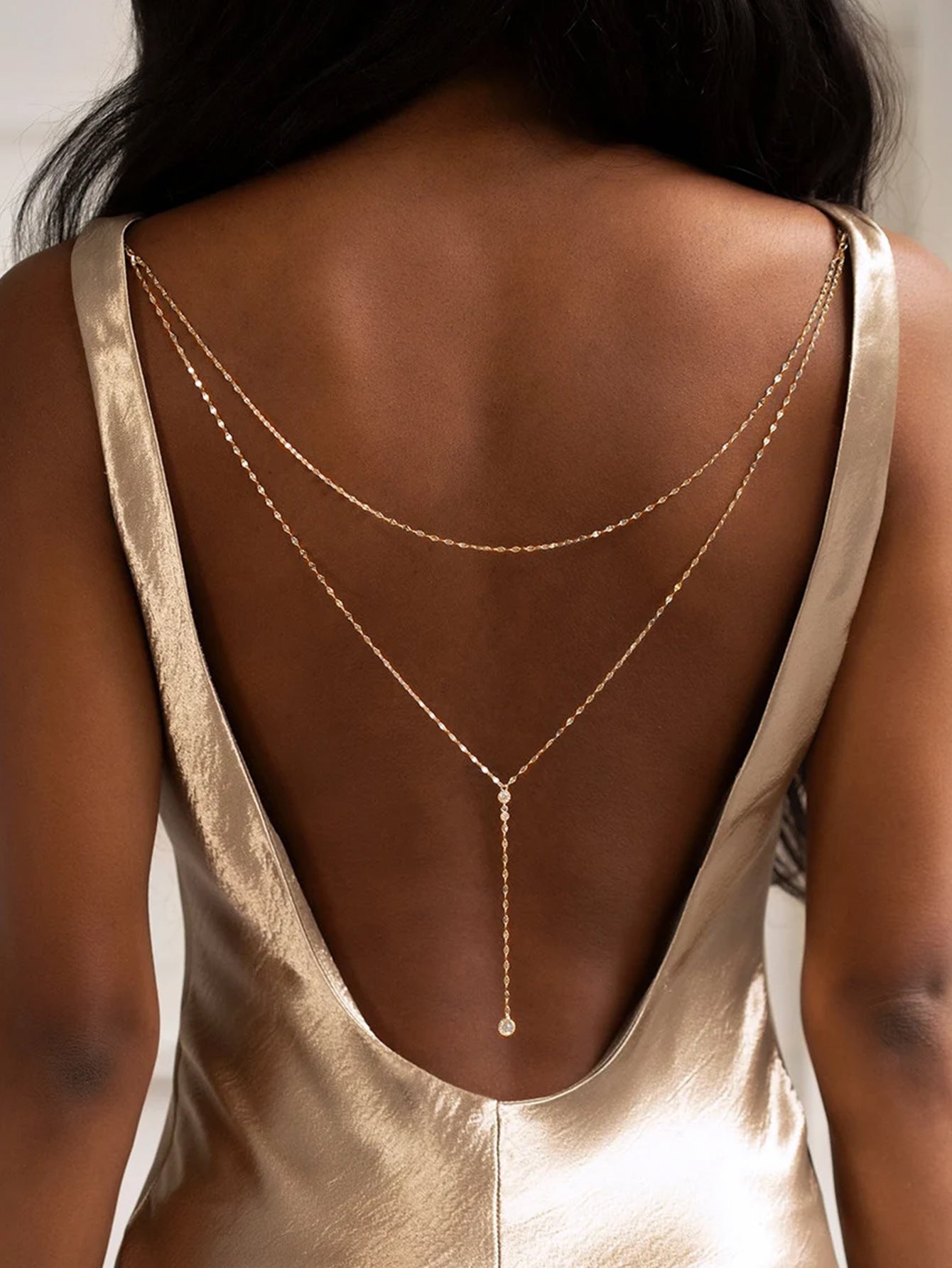 Back drape body chain worn low on a bare back