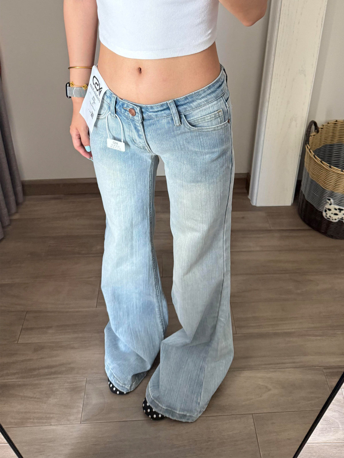 Low rise light wash flared jeans on a model, front view showing the wide flare below the knee