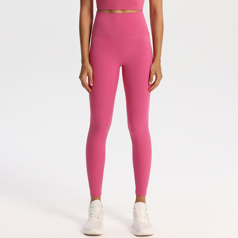 Ankle-length high-waisted yoga leggings in a matte nylon spandex knit on a model