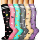 Six knee-high compression socks with striped tops and cartoon pig and panda prints