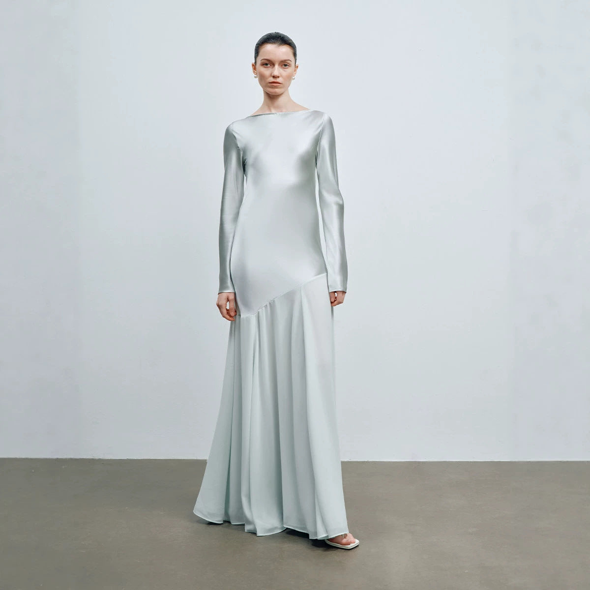 Light mint satin long sleeve boat neck evening gown shown from the front