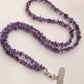 Close-up of polished purple chip beads showing varied tone and irregular shape