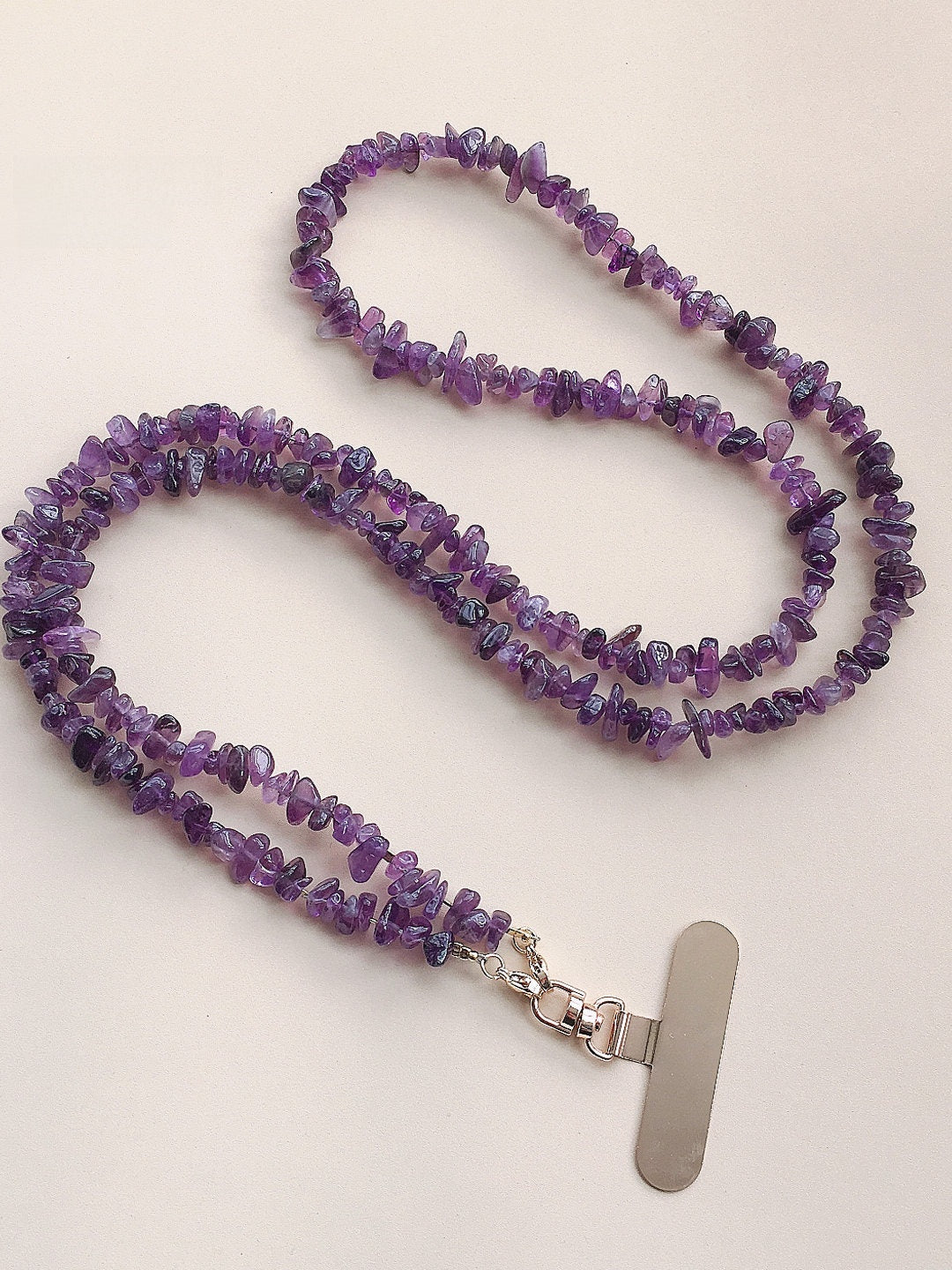 Close-up of polished purple chip beads showing varied tone and irregular shape