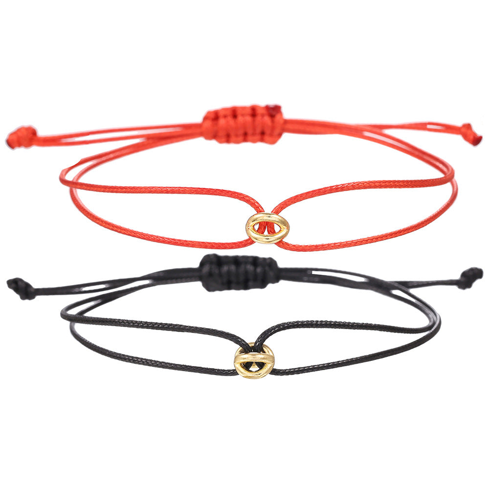 Red and black cord friendship bracelets with gold charms shown flat as a pair