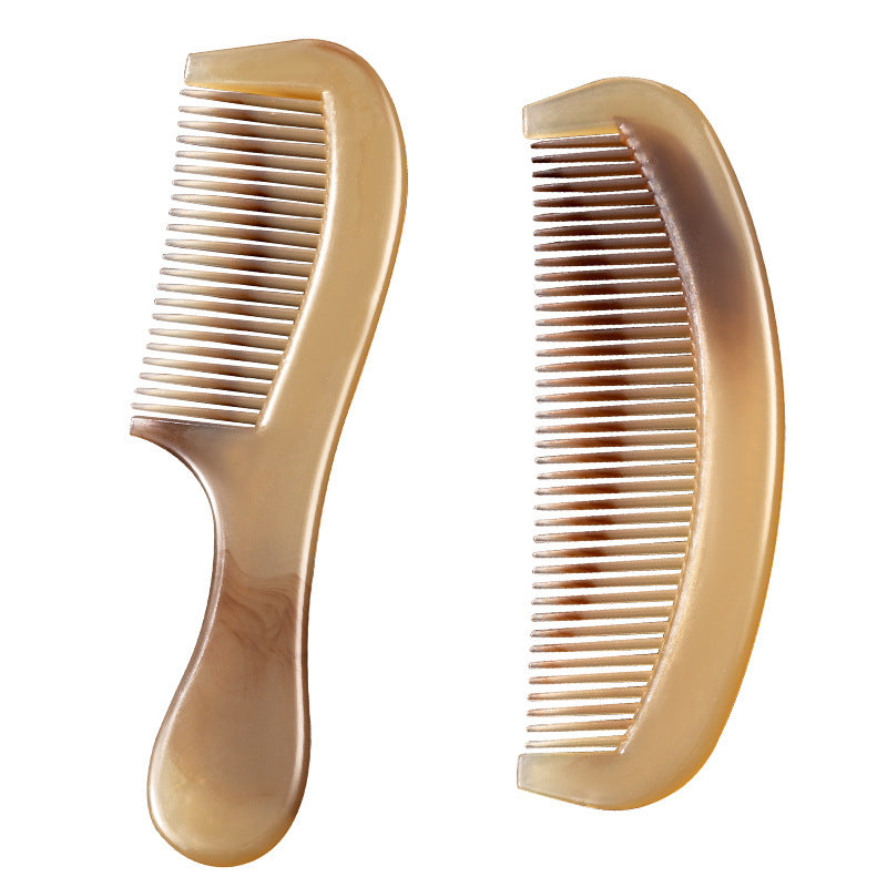 Side view of the marbled hair comb showing its rounded polished teeth and thick spine