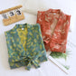 Cotton gauze kimono robe with a kimono collar, tie belt and patch pockets in a leaf print