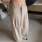Khaki high waist wide leg trousers close up showing belt loops and pressed pleats