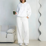 White fleece hooded sweatshirt and wide-leg sweatpants set worn by a model