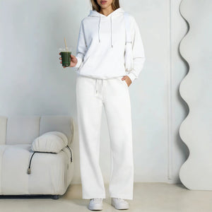 White fleece hooded sweatshirt and wide-leg sweatpants set worn by a model