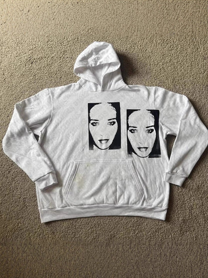 White pullover hoodie flat lay with a washed out double portrait printed across the chest