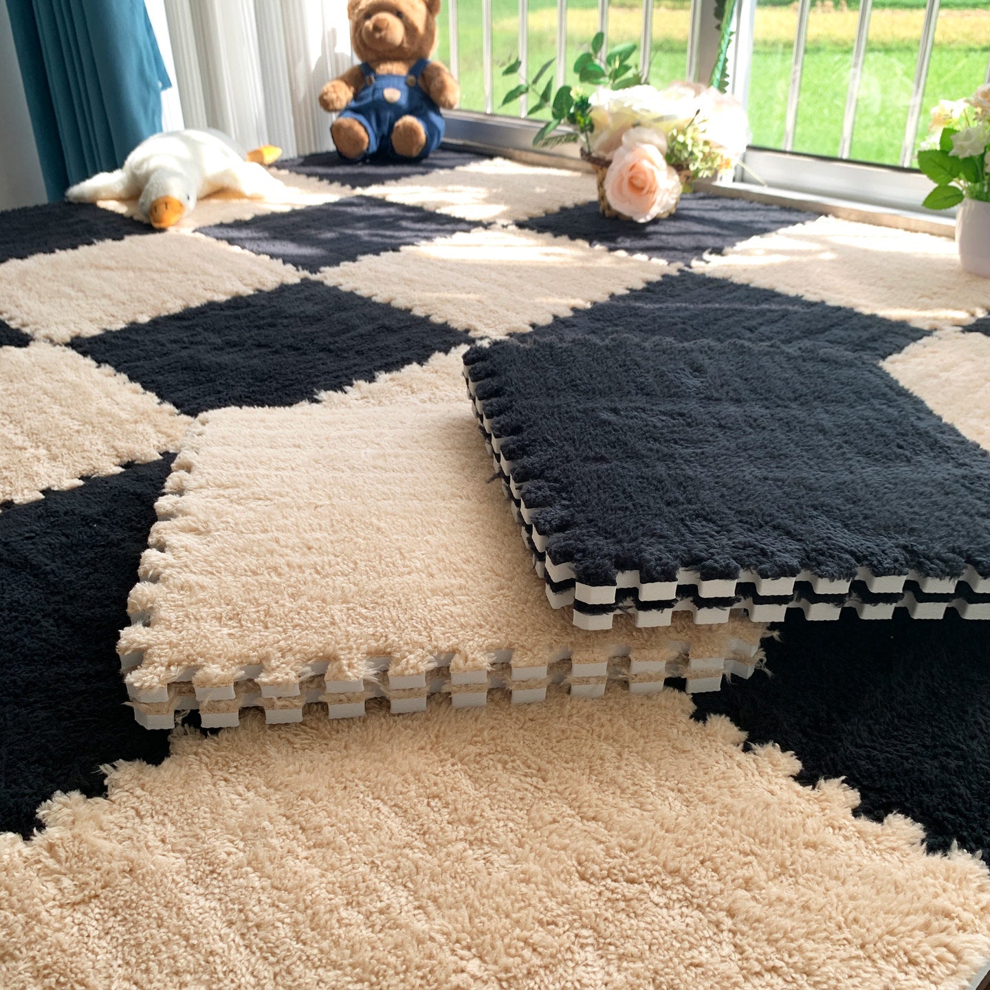 Two modular rug tiles clicking together at their puzzle edges