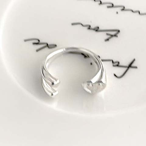 Close up scale reference of the slim open silver ring band and accent