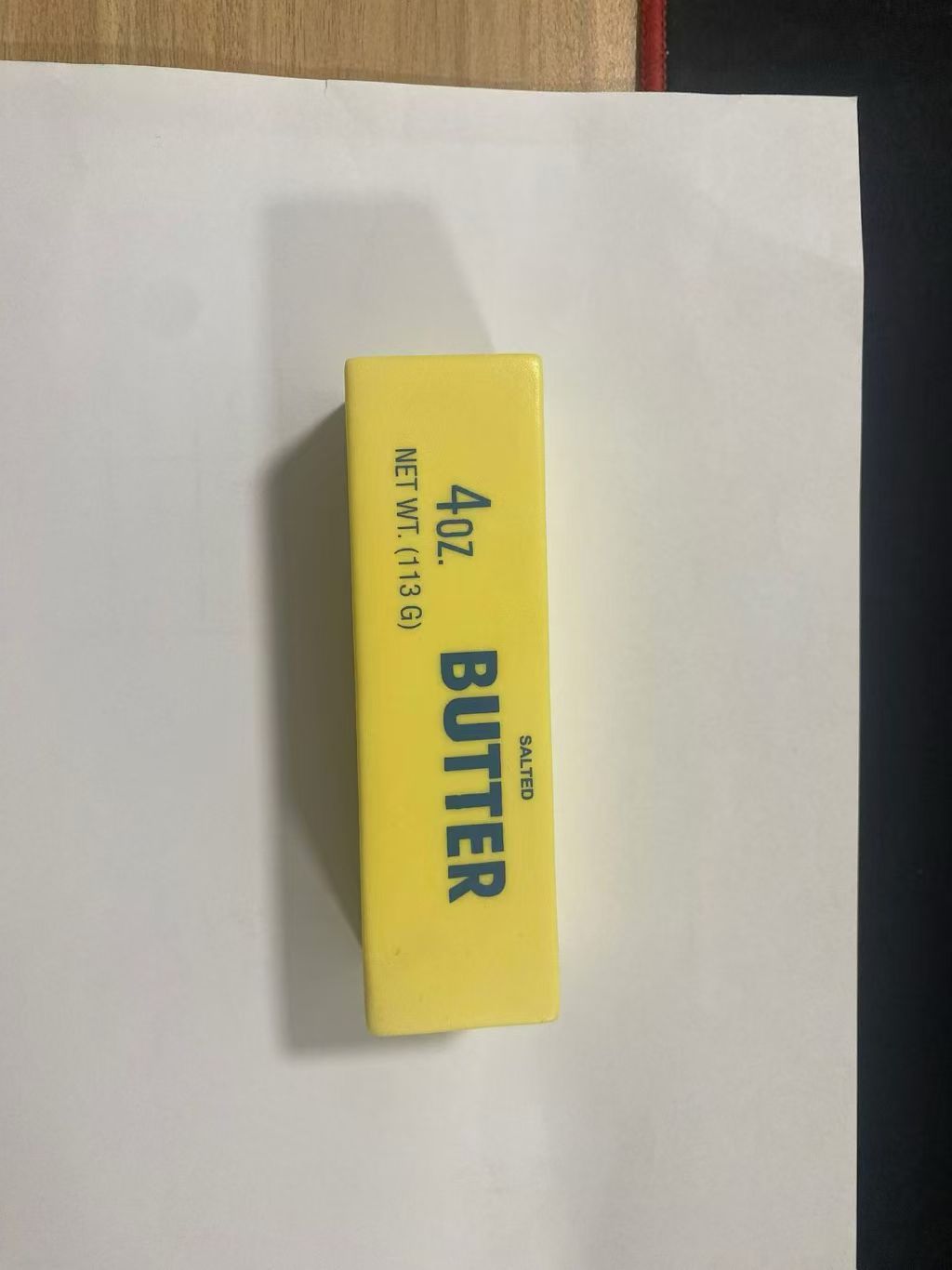 Cheese yellow fruit squishy toy held up showing its soft slow rebound and printed face