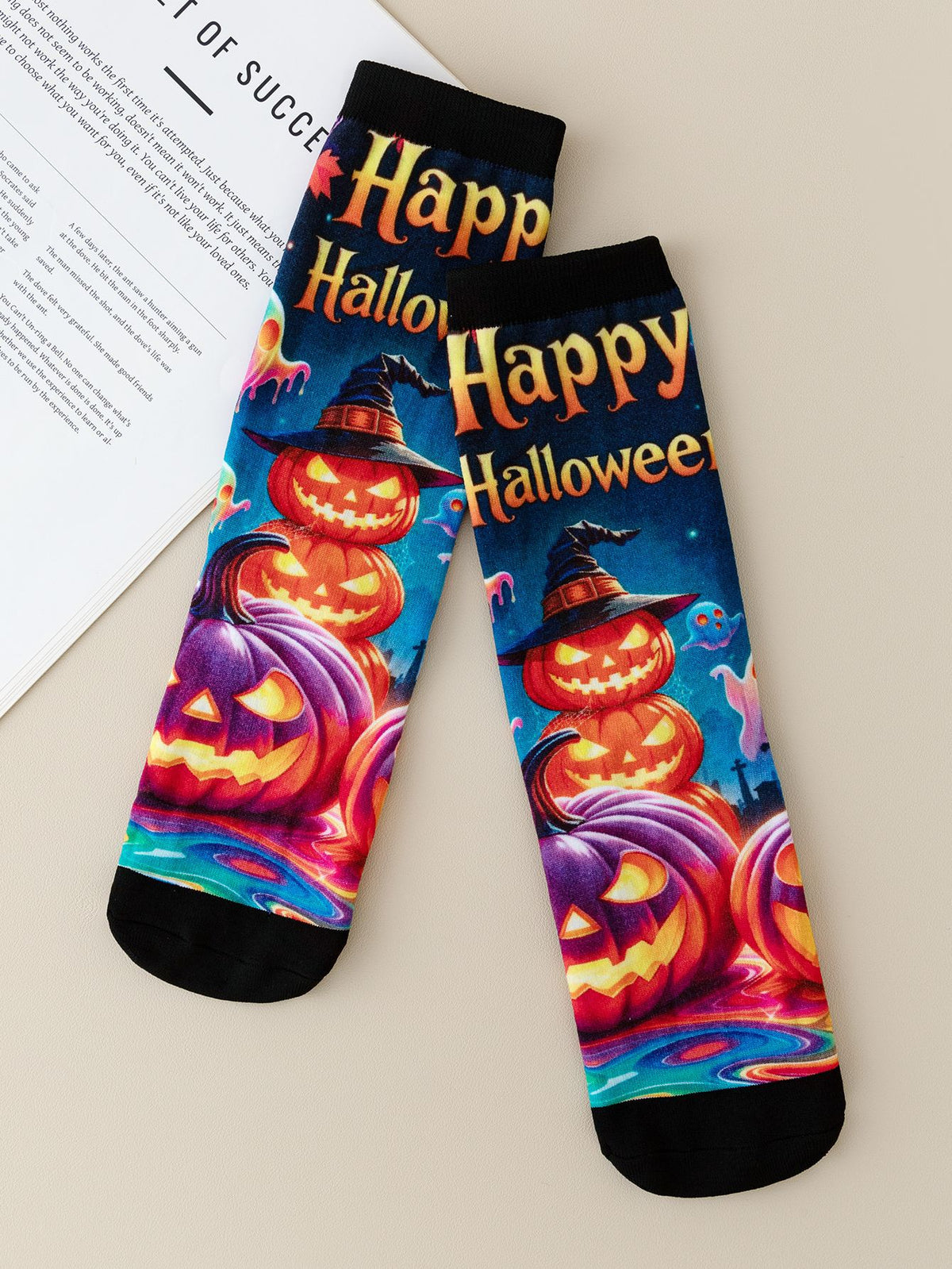 Pair of mid-calf socks printed with stacked grinning pumpkins and the words Happy Halloween