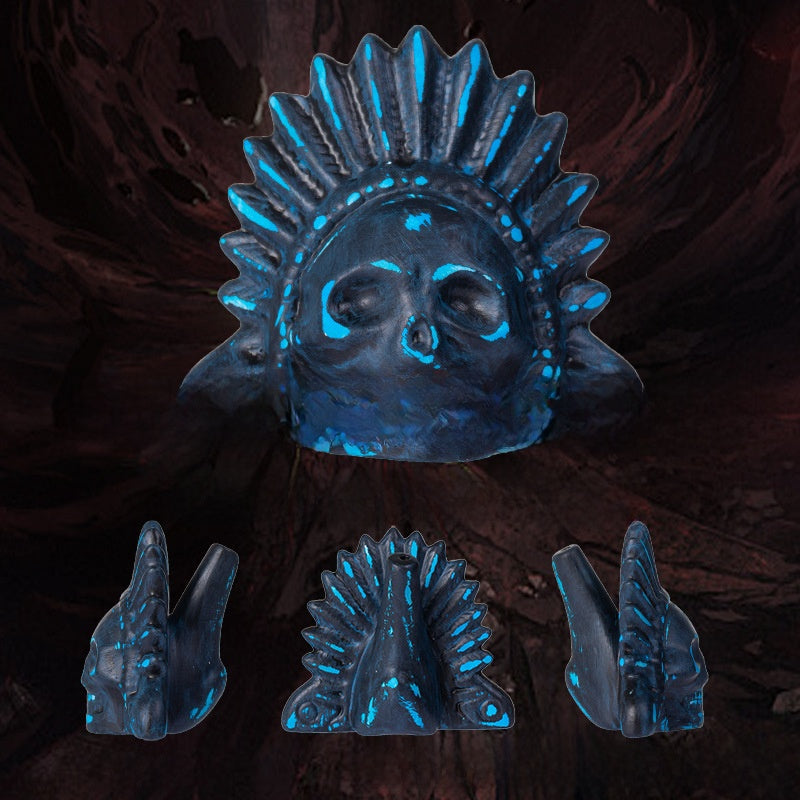 Blue and black ceramic skull death whistle with feather headdress shown with front and side views