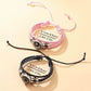 Braided cord bracelets with silver tone beads and celestial charms on a plain background