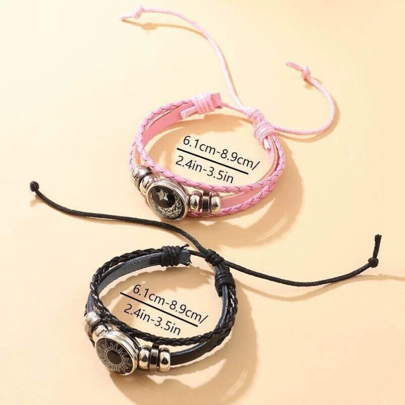 Braided cord bracelets with silver tone beads and celestial charms on a plain background