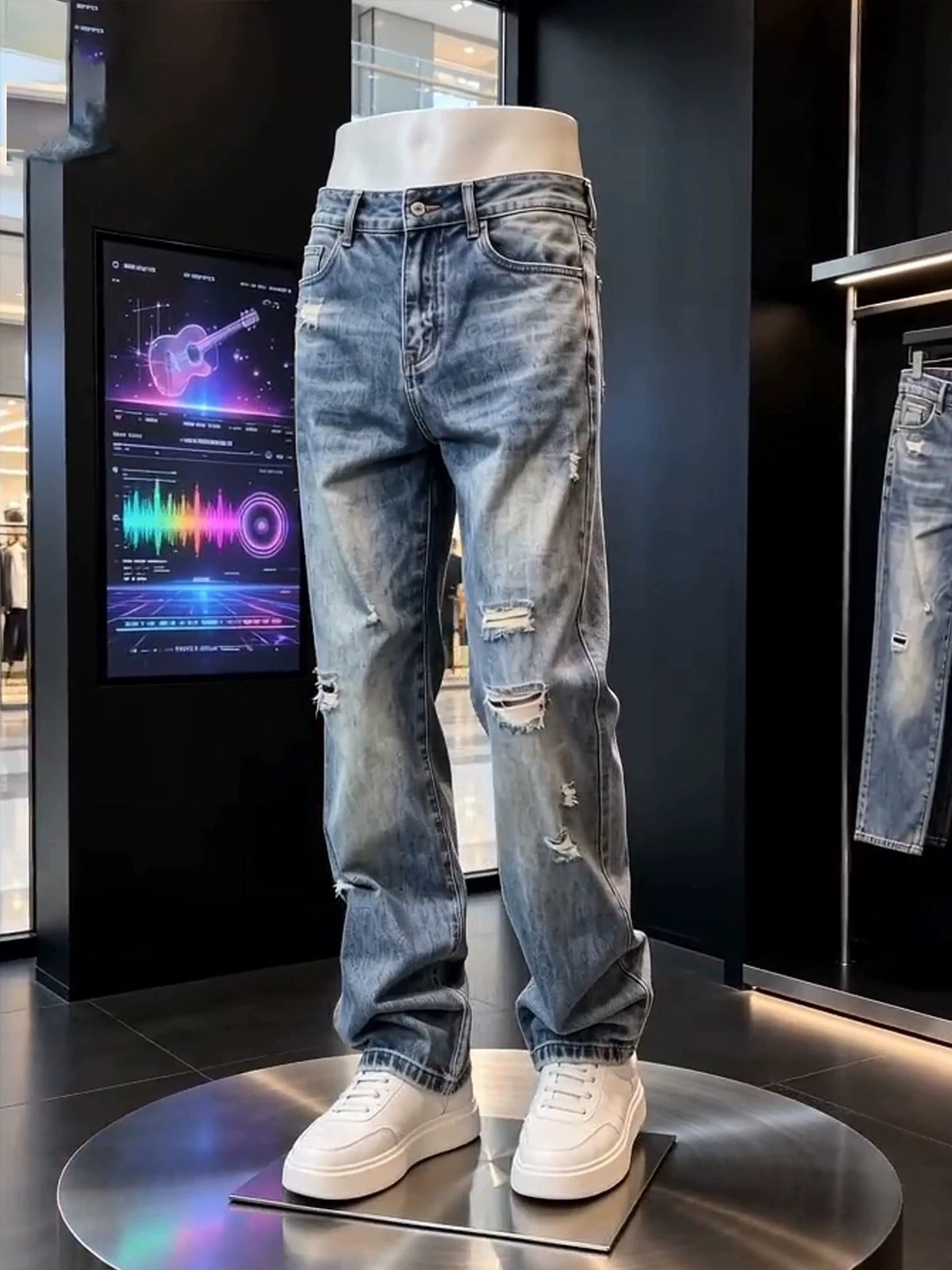 Faded blue distressed straight leg jeans with rips at the thigh, front view on a display mannequin