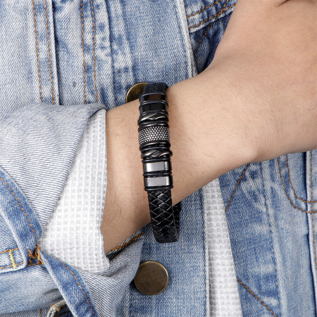 Close view of the magnetic slide clasp on a black braided leather bracelet