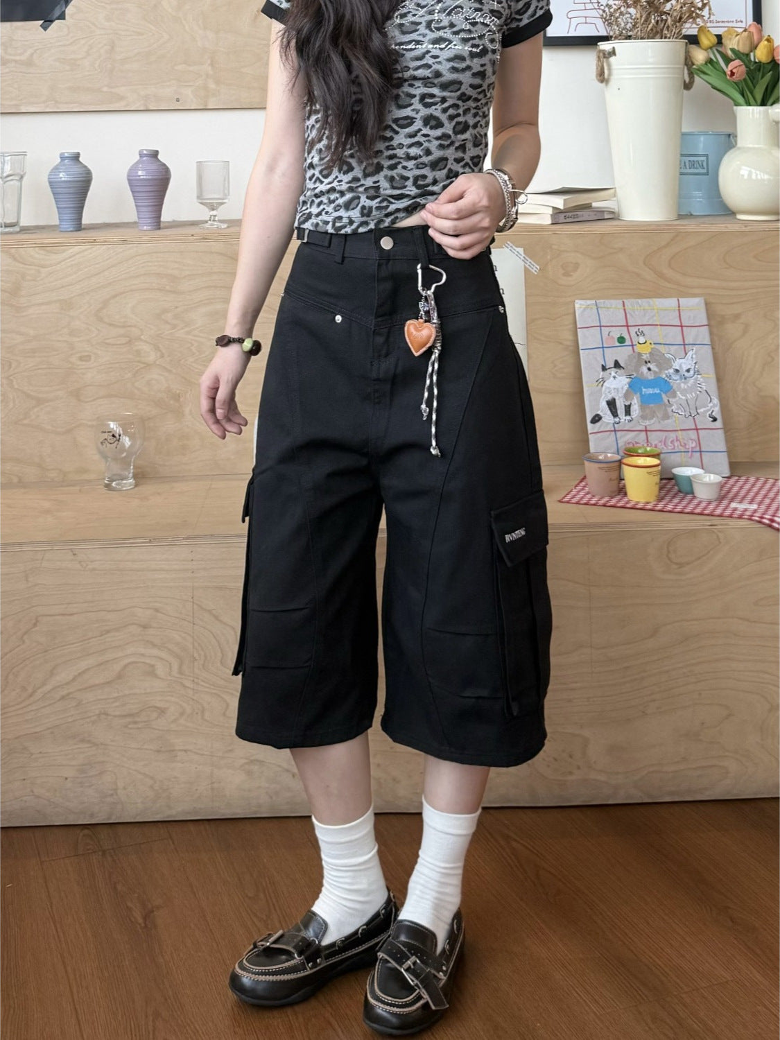 Black high waist cargo pants with flap pockets and belt loop detail front view